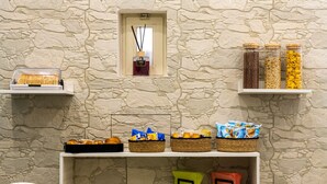 A breakfast buffet setup with various food items and condiments on shelves against a stone wall. - B&B alla Ferrovia (Naples)