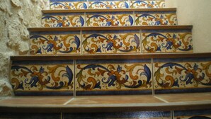 A staircase with ornate, multicolored tiles. - Ca L'Estruch (Vallclara)