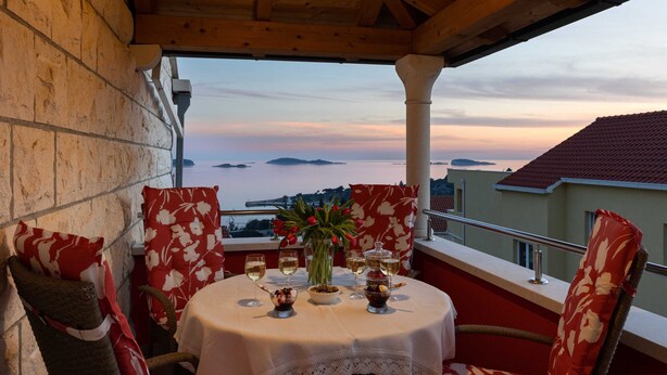 A table set for two with a view of the sea and distant islands. - Apartments Subrenum (Zupa dubrovacka)