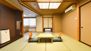 A traditional Japanese room with tatami flooring, a low table, and cushions. - Ooedo Onsen Monogatari Hotel Kinugawa Gyoen (Nikko)