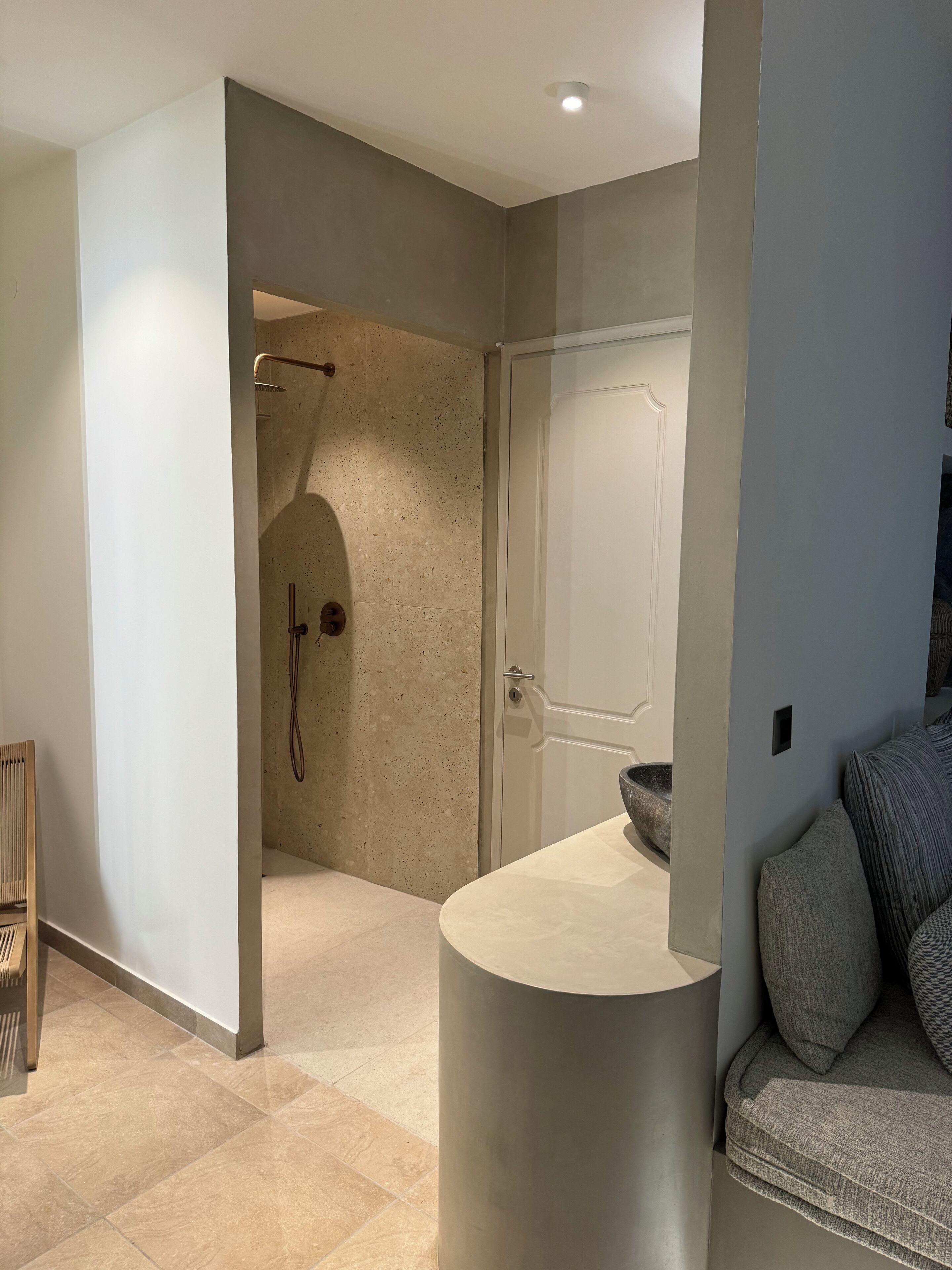 A modern bathroom with a shower, a sink, and a toilet.