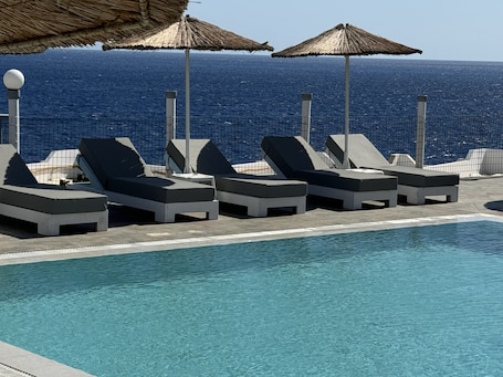 Outdoor pool, pool umbrellas, pool loungers. CHC Sound of the Sea