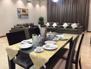 Deluxe Apartment, 1 Bedroom | Living area | 40-inch LED TV with satellite channels, TV - RURU Tower (Manama)