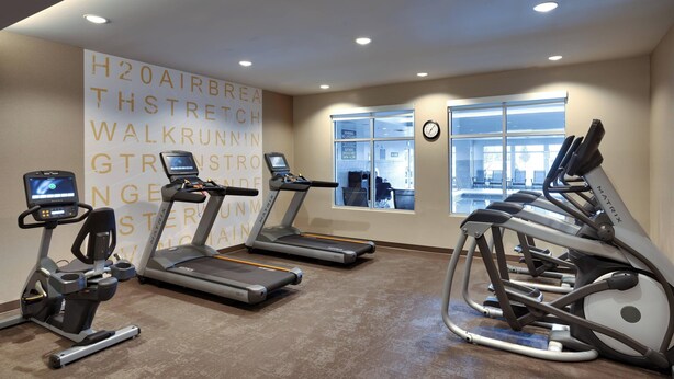 A gym with treadmills, an elliptical, and a stationary bike. - Residence Inn by Marriott Provo South University (Provo)