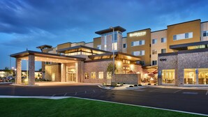 A modern hotel with a spacious entrance, multiple floors, and a well-lit facade. - Residence Inn by Marriott Provo South University (Provo)