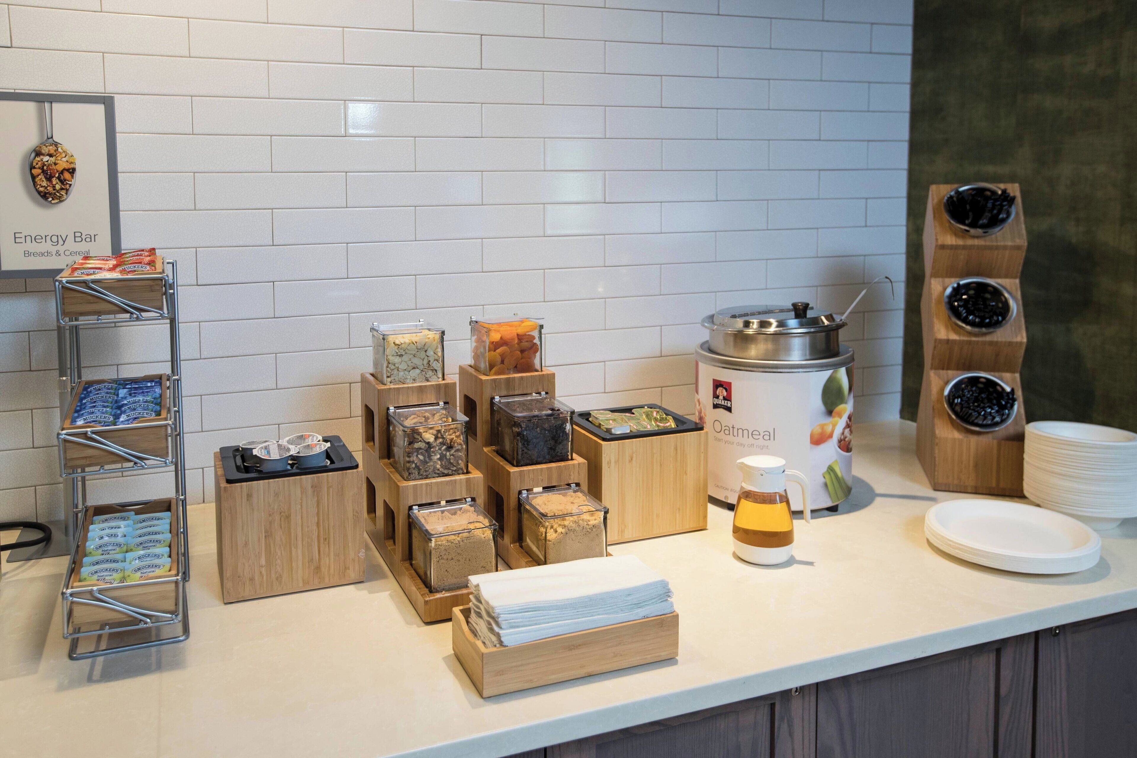 A breakfast bar with various food items and a coffee station.