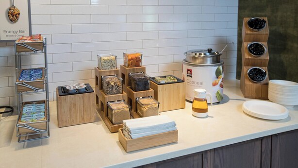 A breakfast bar with various food items and a coffee station.