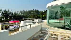 A modern building with a glass facade and a curved structure. - Inani Royal Resort (Cox's Bazar)