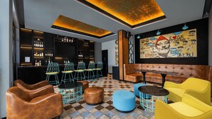 A bar area with seating, a checkered floor, and a mural on the wall. - Fairfield by Marriott Sriperumbudur (Sriperumbudur)