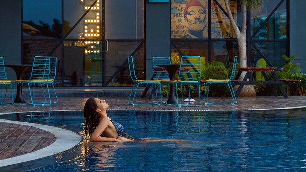 A pool area with lounge chairs and a sign reading "Do's". - Fairfield by Marriott Sriperumbudur (Sriperumbudur)