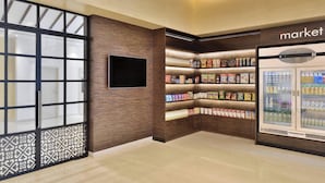 A modern retail area with a variety of packaged goods on shelves and refrigerated sections. - Fairfield by Marriott Sriperumbudur (Sriperumbudur)