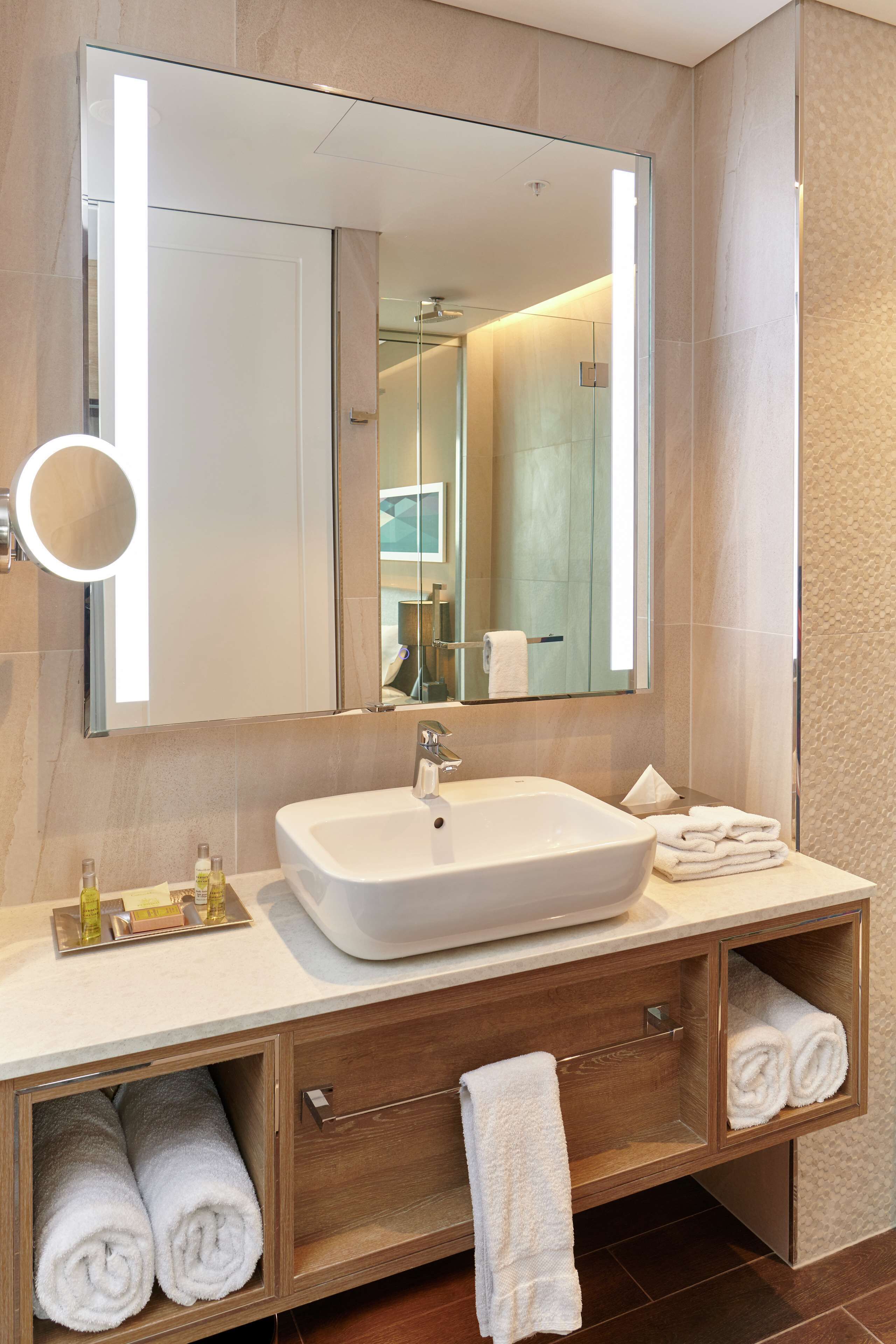 designer toiletries, hair dryer, slippers, towels