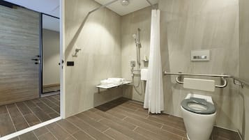 A modern bathroom with a shower, toilet, and a towel rack.