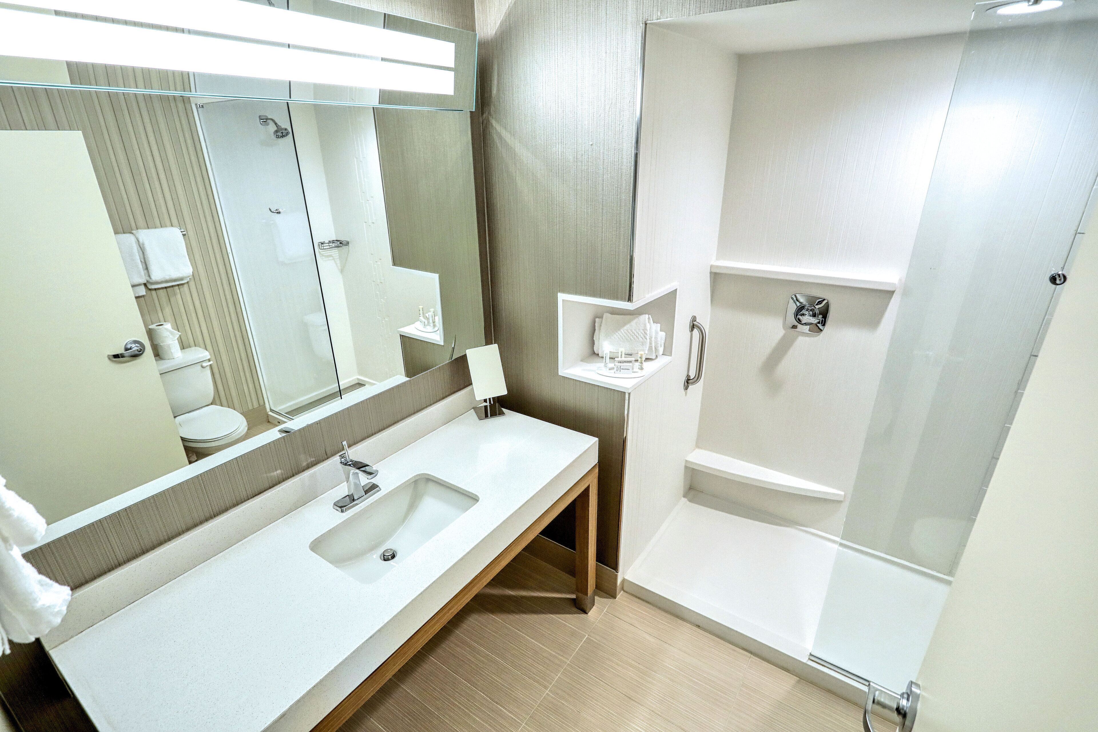 designer toiletries, hair dryer, towels, soap