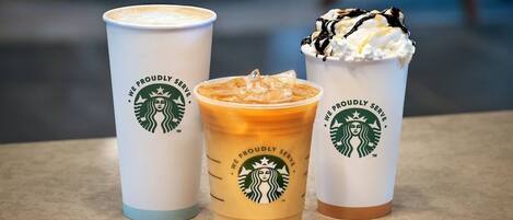 Three Starbucks cups with different beverages.