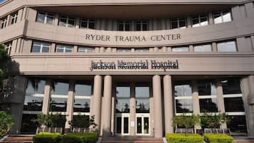 The exterior of the Ryder Trauma Center at Jackson Memorial Hospital, featuring a symmetrical facade with large windows and a central entrance.