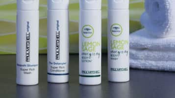 Four bottles of Paul Mitchell hair care products on a bathroom counter.