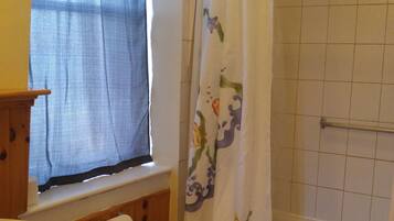 A bathroom with a sink, toilet, and bathtub.