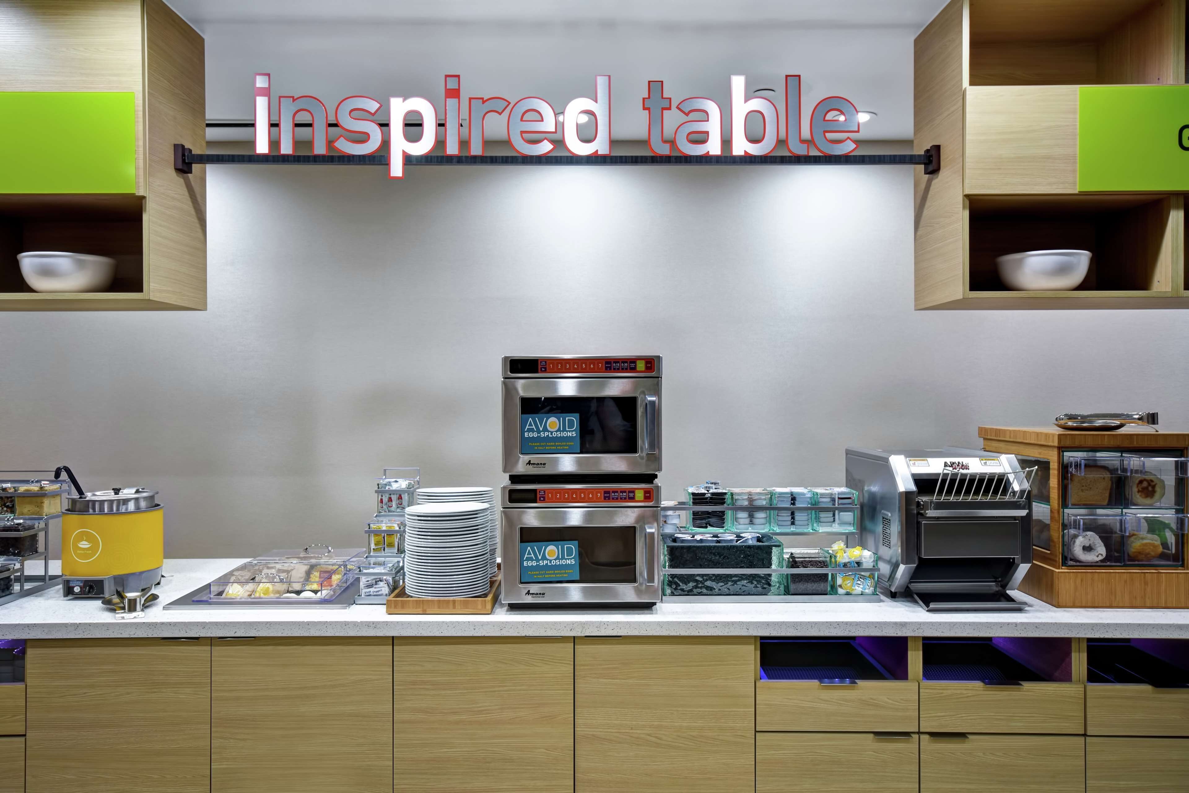 A breakfast bar with various appliances and food items.