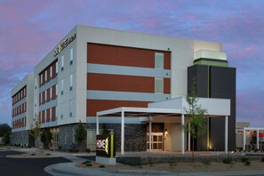 A modern hotel with a prominent 'HOME 2 SUITES BY HILTON' sign, a covered entrance, and a stone facade. - Home2 Suites by Hilton Longmont (Longmont)