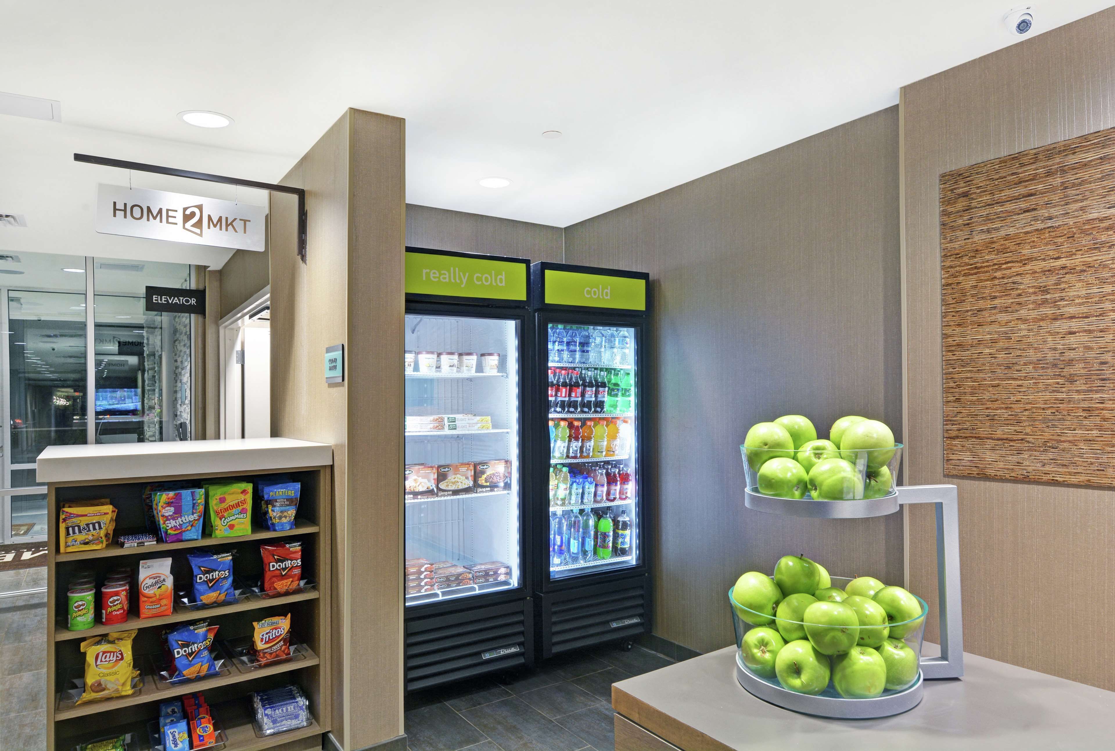 A snack display with chips and a fruit stand.