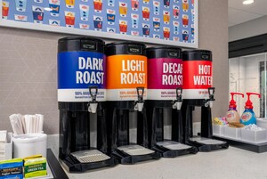 Four coffee dispensers labeled DARK ROAST, LIGHT ROAST, DECAF ROAST, and HOT WATER, each with a coffee brand name.