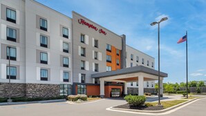 A Hampton Inn hotel with a modern facade, a welcoming entrance, and an American flag. - Hampton Inn Baltimore Bayview Campus (Baltimore)