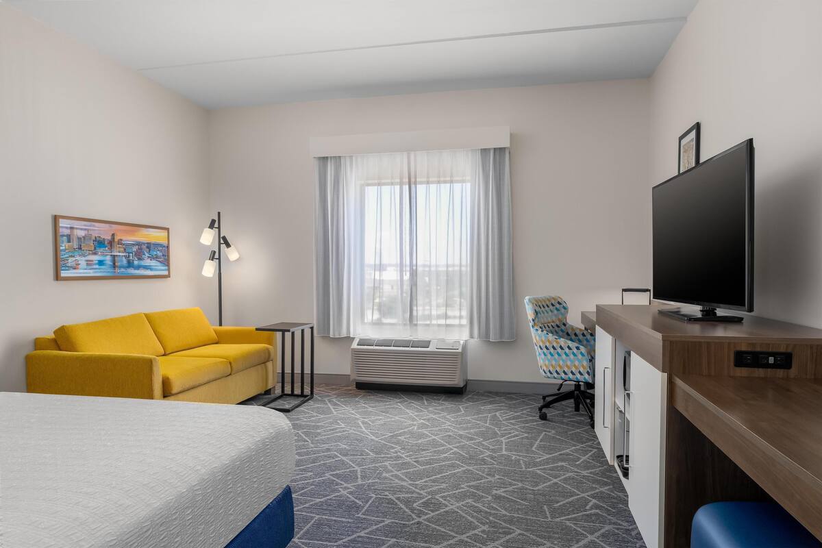 Room, 1 King Bed with Sofa bed, Refrigerator | Living area | 42-inch TV with digital channels