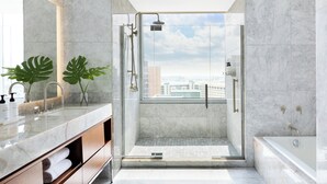 A modern bathroom with a glass-enclosed shower, a bathtub, and a large vanity with a mirror. - InterContinental Houston by IHG (Houston)