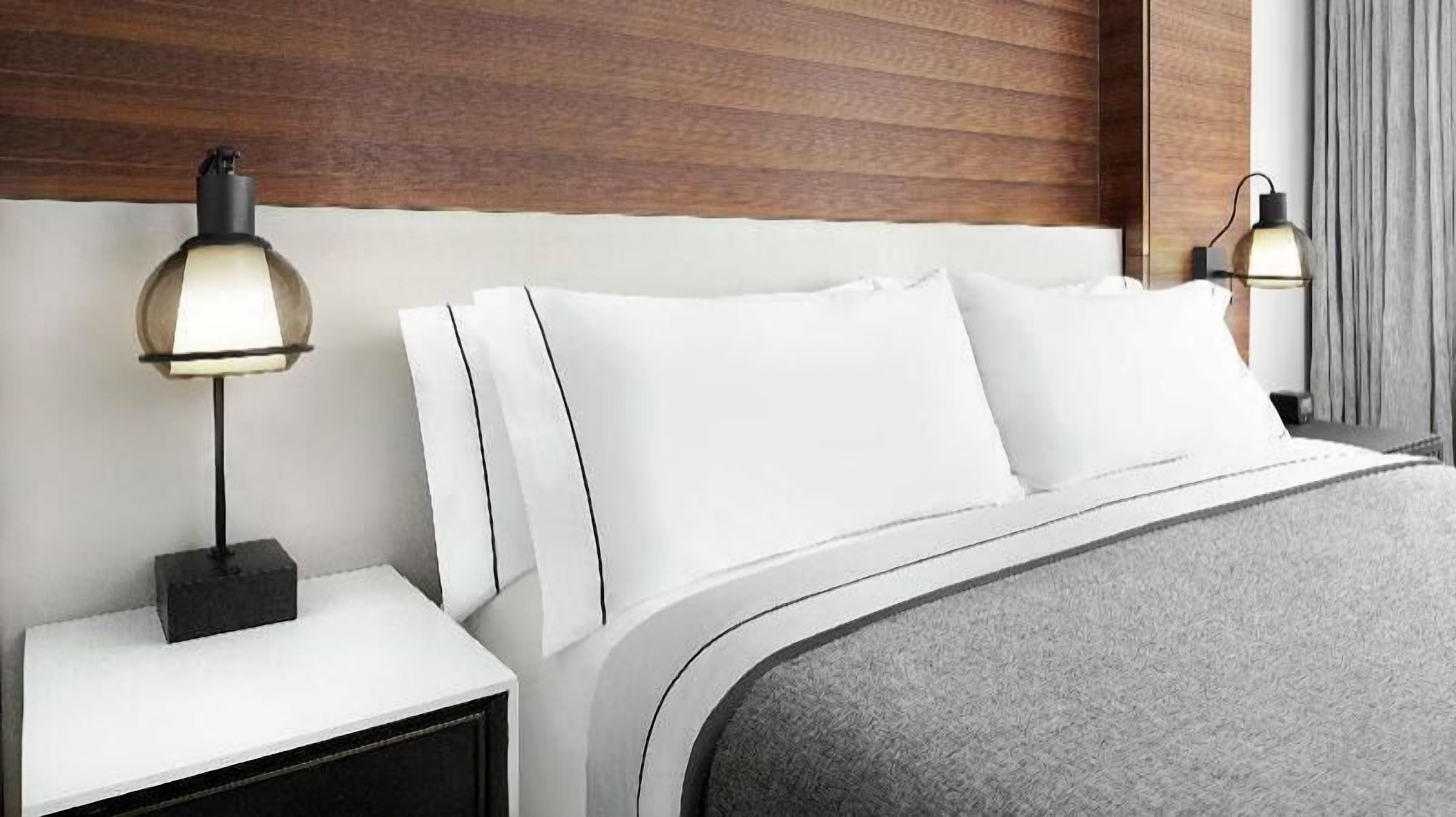 Ropa de cama de alta calidad y caja de seguridad en la habitación 