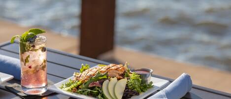 A meal on a table by the water.