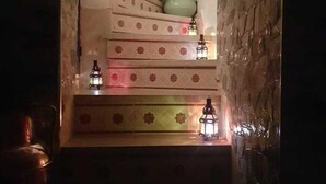 A staircase with decorative tiles and a potted plant at the top. - Sun Hostel Marrakech (Marrakech)