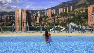 Outdoor pool, open 6 AM to 8 PM, pool loungers, lifeguards on site