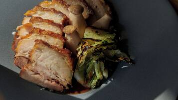 A plate with sliced meat and vegetables.
