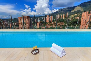 Outdoor pool, open 6 AM to 8 PM, sun loungers, lifeguards on site