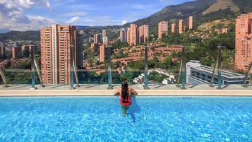 Outdoor pool, open 6 AM to 8 PM, pool loungers, lifeguards on site