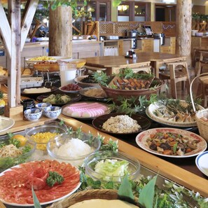 A buffet with various dishes and a wooden interior.