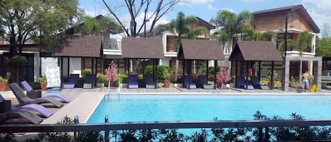 Outdoor pool, a natural pool, free pool cabanas, pool umbrellas