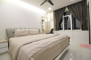 A bedroom with a bed, a desk, a chair, a window with curtains, and a ceiling fan. - H2H Maison De Luxe (Ipoh)