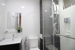 A modern bathroom with a white sink, toilet, and shower area. - H2H Maison De Luxe (Ipoh)