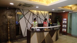 A reception desk with a modern design, featuring geometric patterns and a marble floor. - Bhimaas Temple Tree (Chennai)