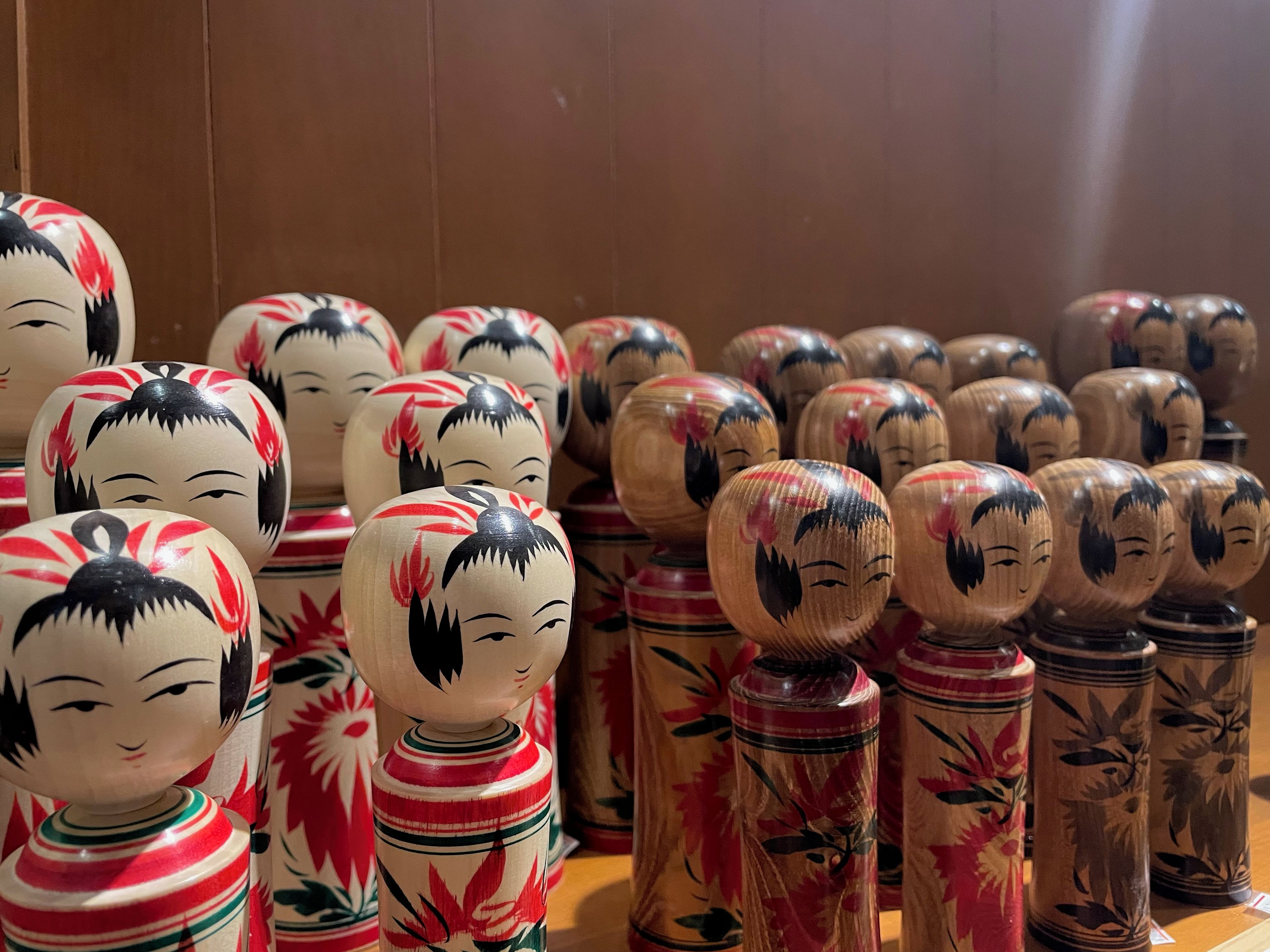 A collection of wooden figures with painted faces and floral patterns.