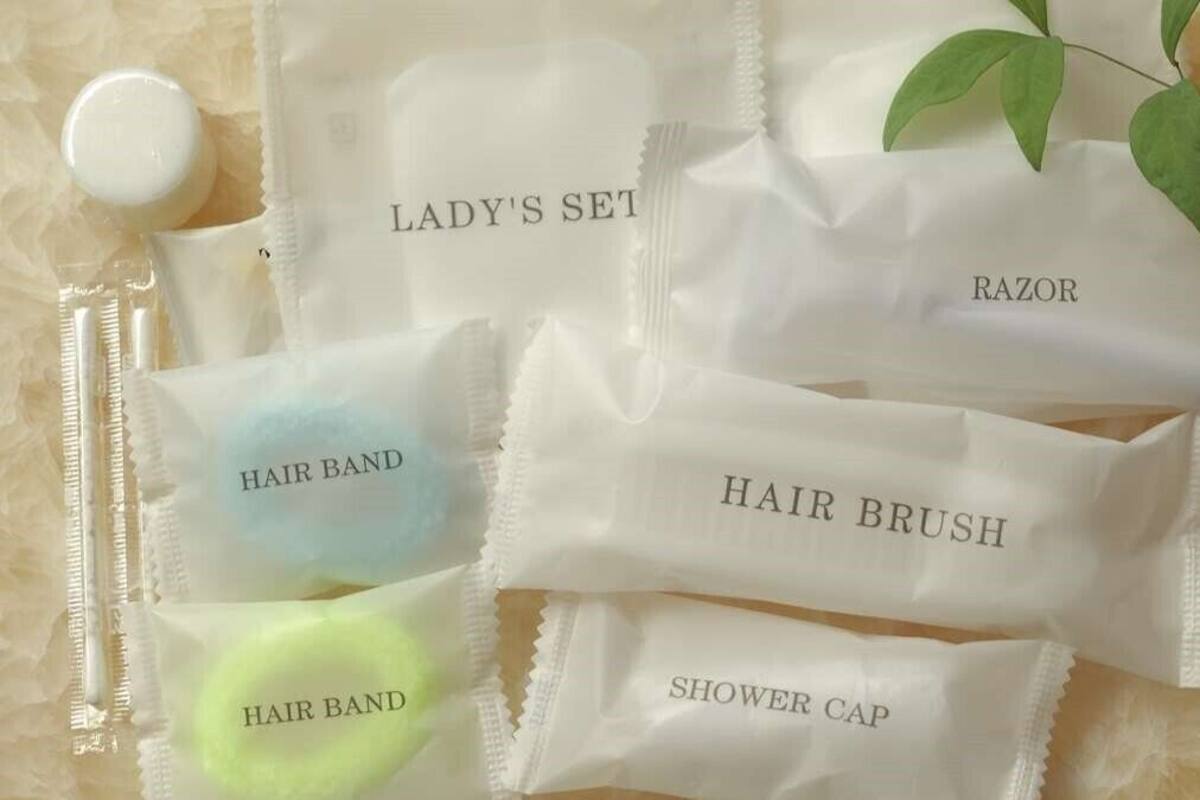 A set of personal care items including a razor, hair brush, and shower cap.