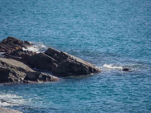 A rocky coastline with clear blue water.