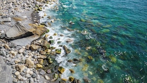 A rocky shoreline with clear blue water. - Unda de Ma Apartment with AC & Sea View Balcony (Vernazza)