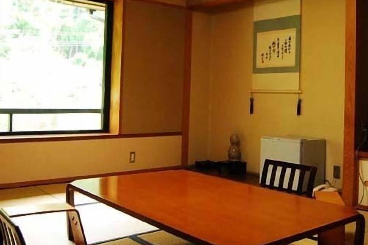A traditional Japanese room with tatami flooring, a low table, and a shoji screen.