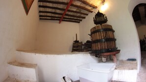 A rustic interior with a wooden barrel, a white basin, and a staircase.