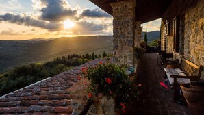 A stone building with a terrace overlooking a mountainous landscape. - the best location in the Maremma for maremmaguide (pari)