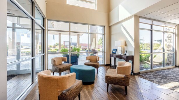 A spacious lobby with large windows, wooden flooring, and several seating areas. - Best Western Plus Bolivar Hotel & Suites (Bolivar)