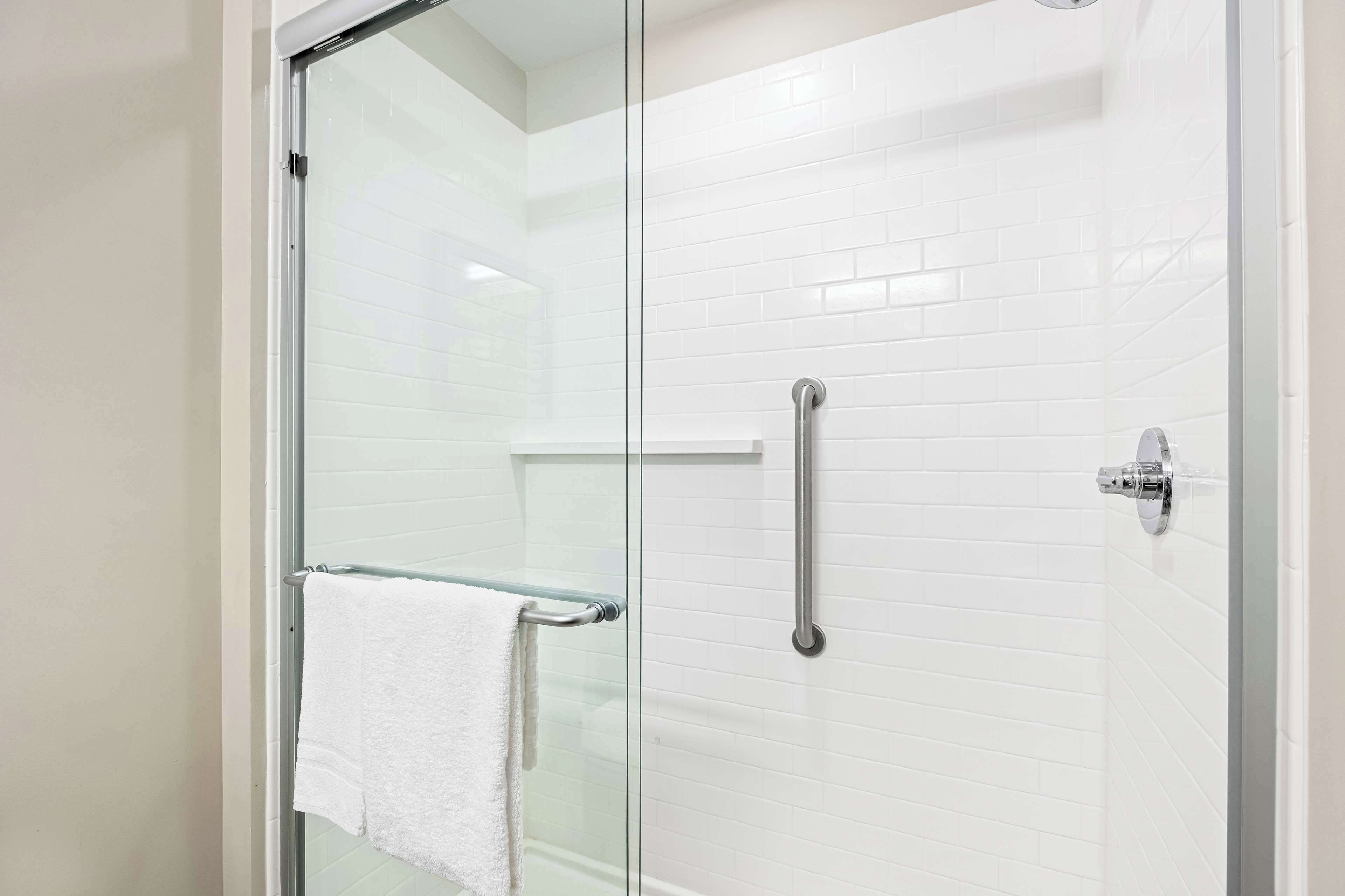 combined shower/bathtub, designer toiletries, hair dryer, towels